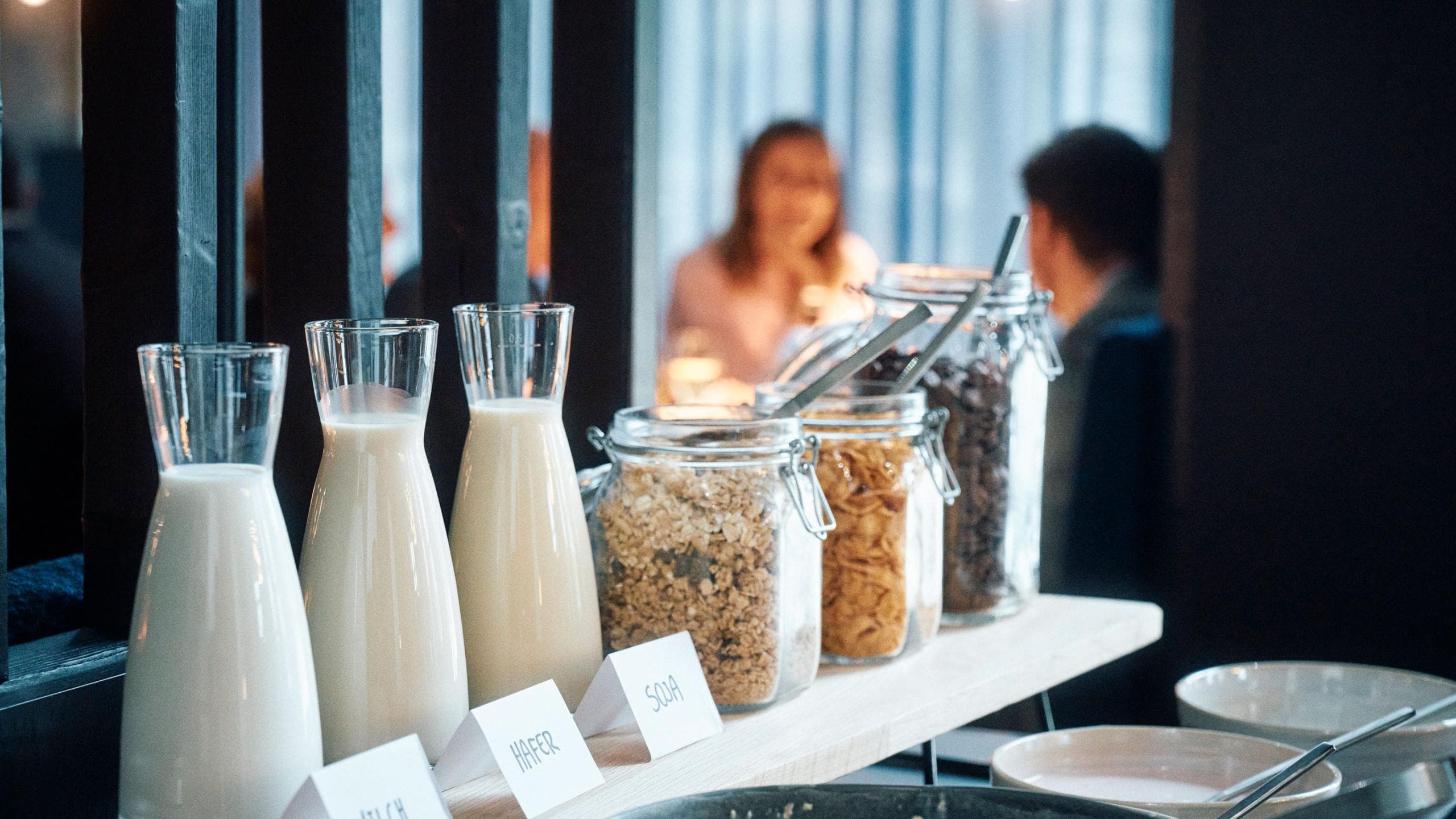 A brightly lit brunch spread of pastries, fruit and warm dishes laid out on a table inside the Bergson Kunstkraftwerk.