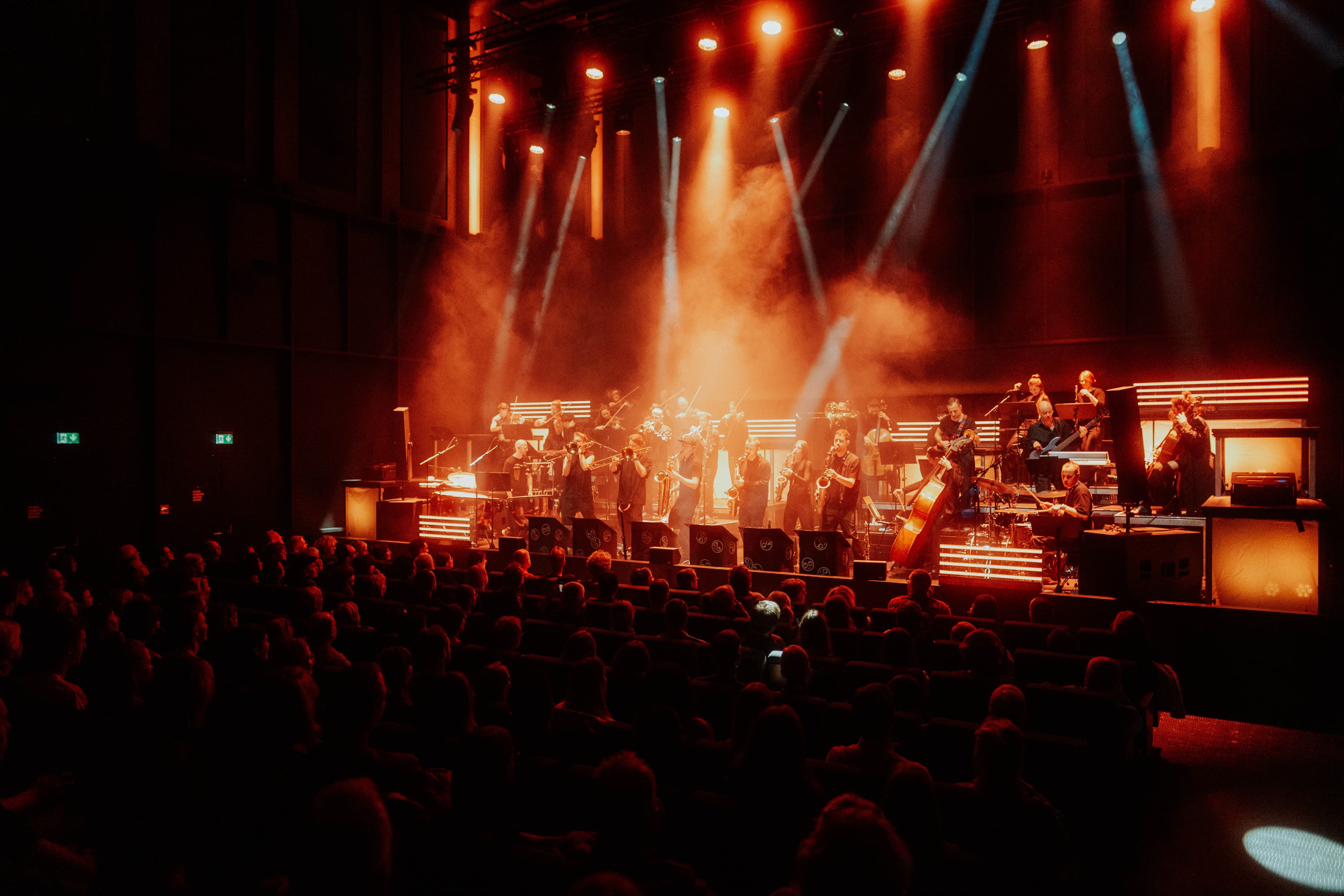 The Jazzrausch Bigband performing on stage under coloured concert lighting at Bergson.