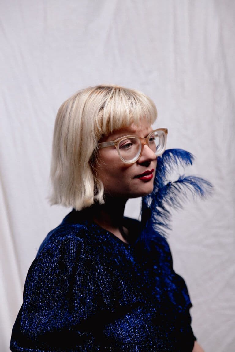 Portrait of musician Mary Ocher standing outdoors, photographed by Kasia Sekula.