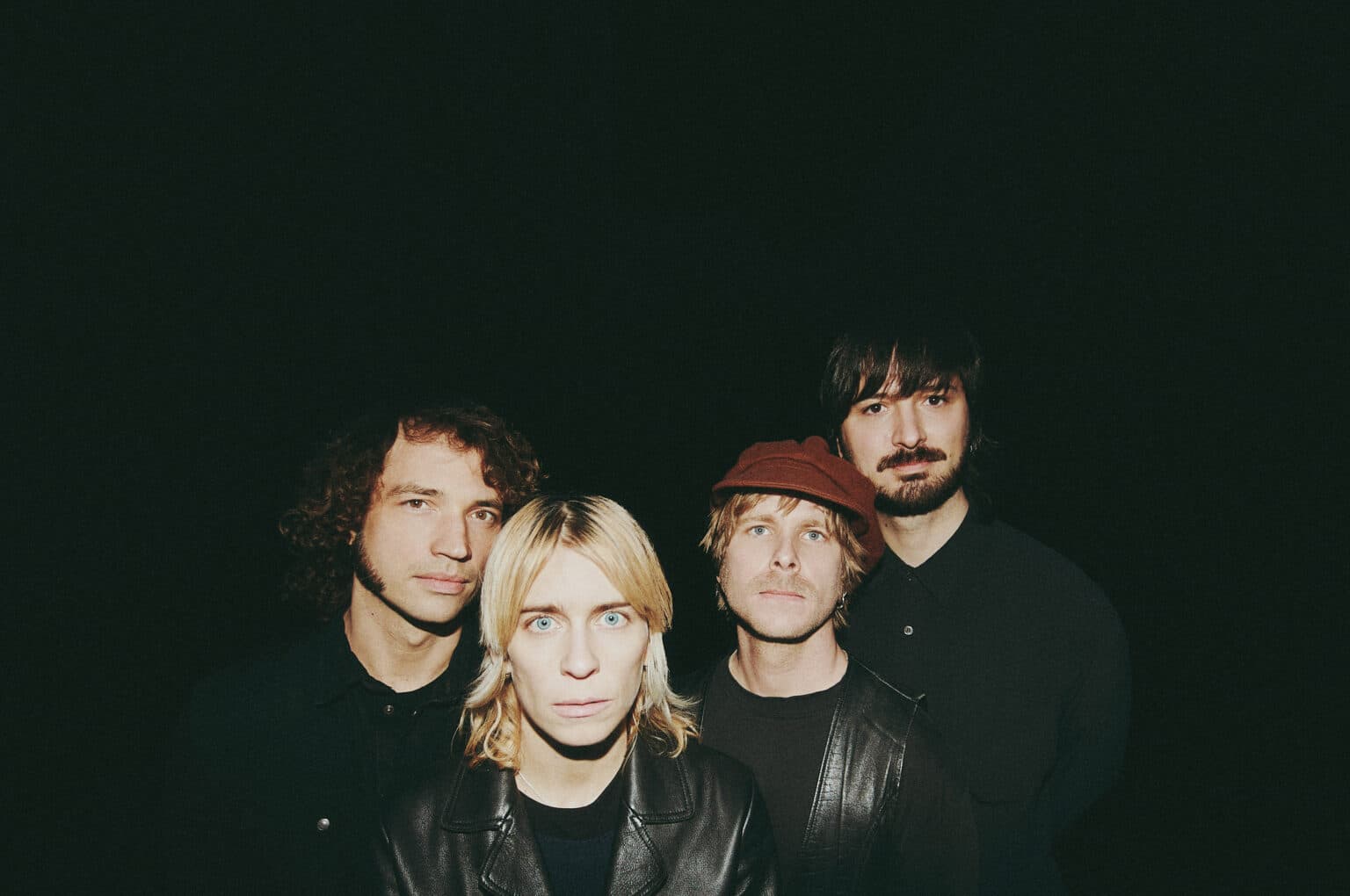 The band Annie Taylor posed together, photographed by Christian Taro.