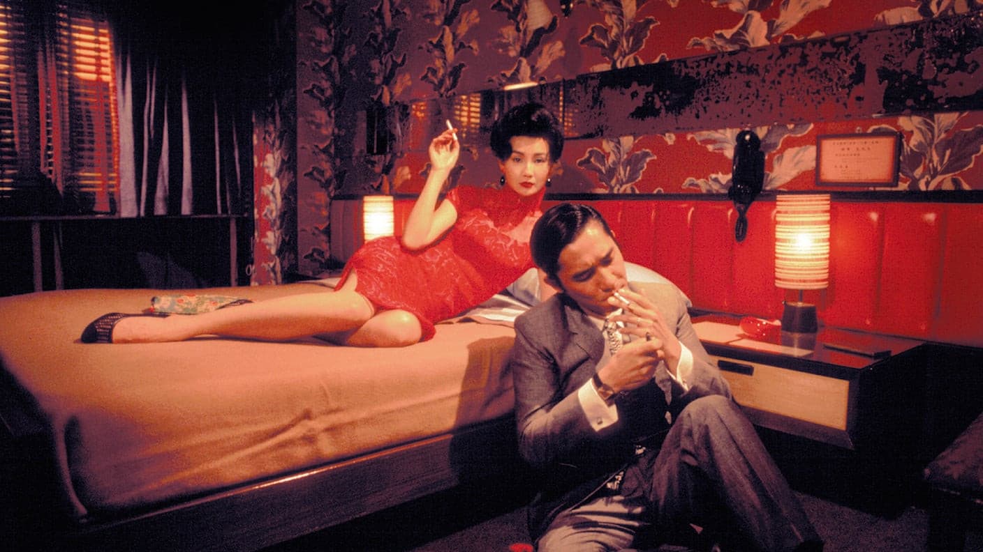 Still from In the Mood for Love with a woman in a patterned cheongsam in a corridor