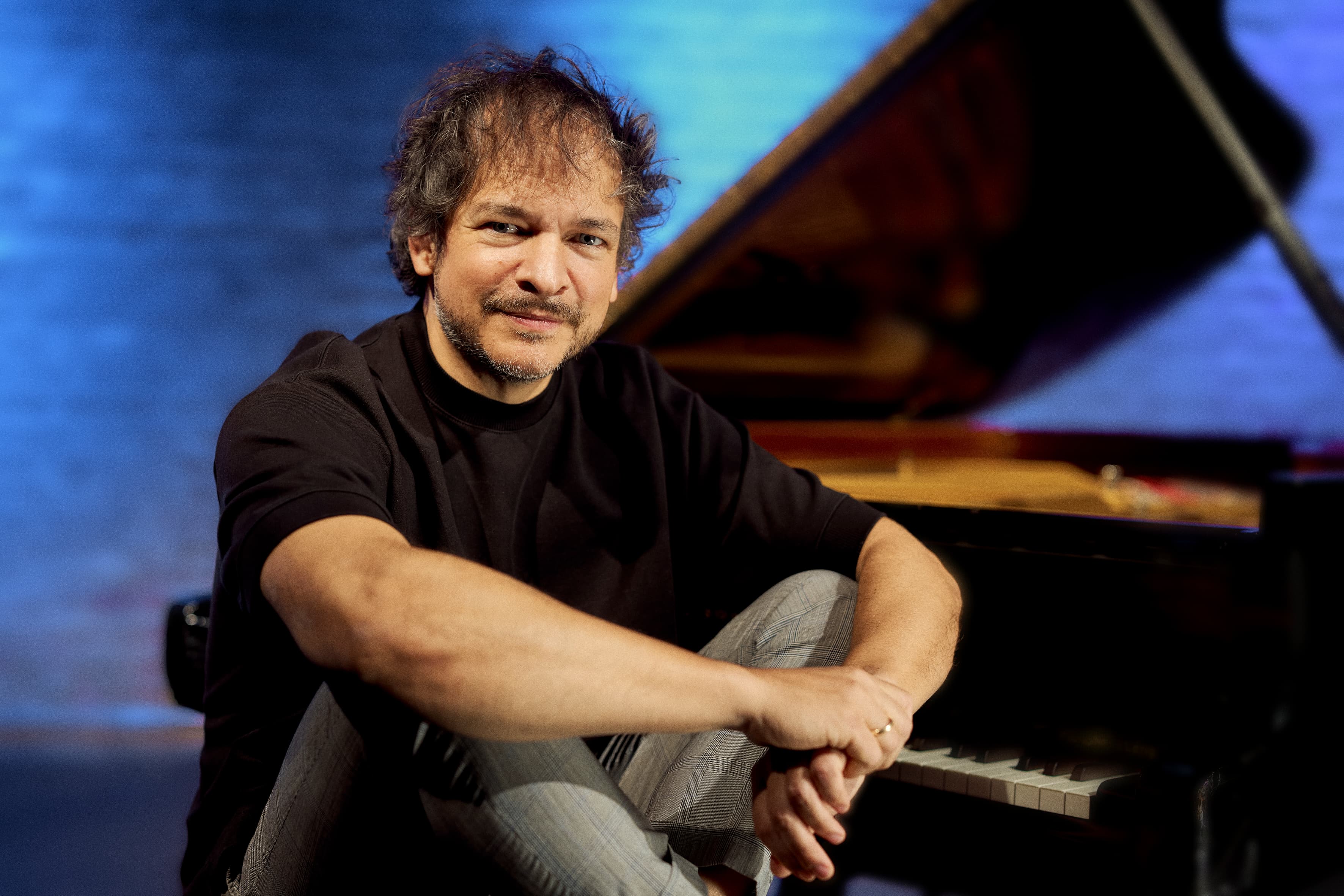 Pianist Chris Gall photographed in a relaxed portrait pose.