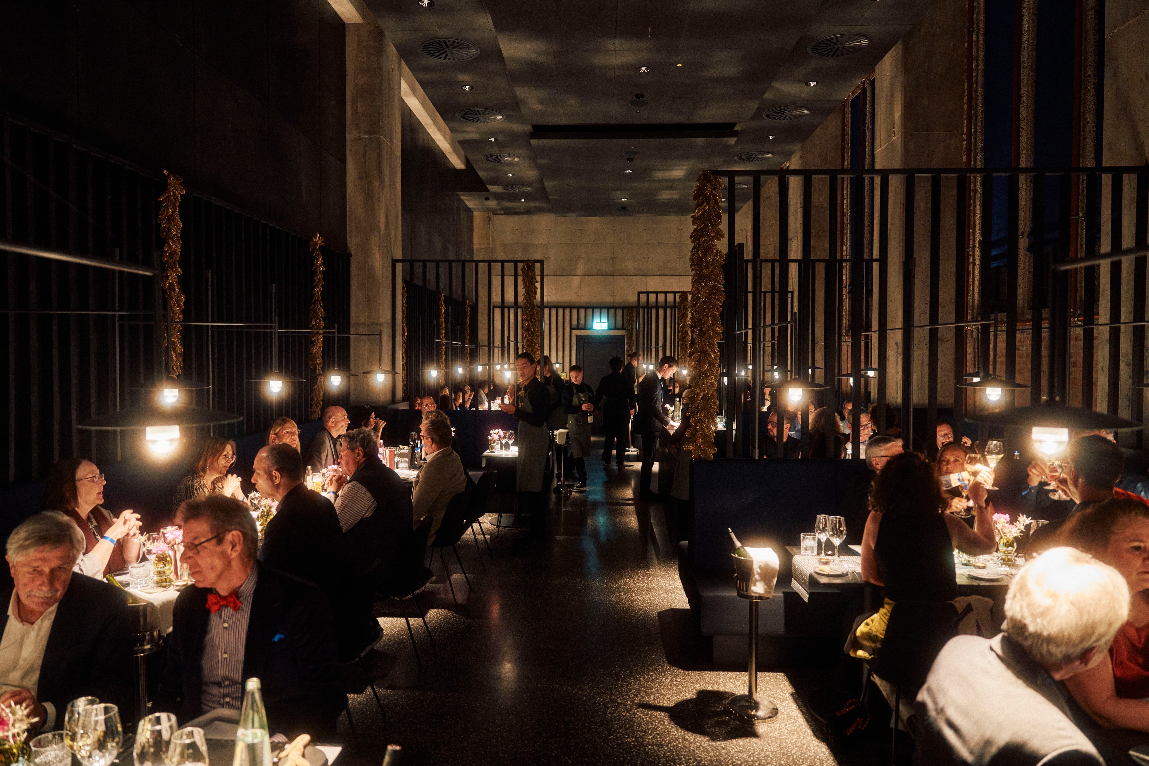 Guests dining and celebrating under the high vaulted ceiling of Bergson's former power-plant hall.