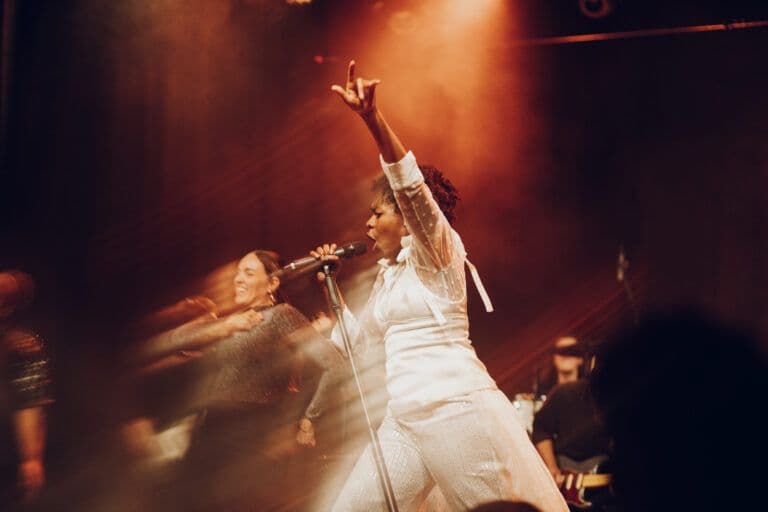 The band Ki'Luanda performing live on a concert stage.