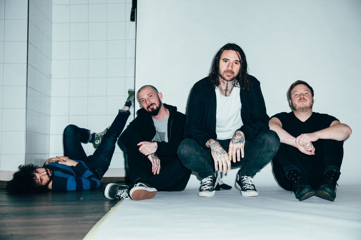 The three members of Coilguns photographed together outdoors.