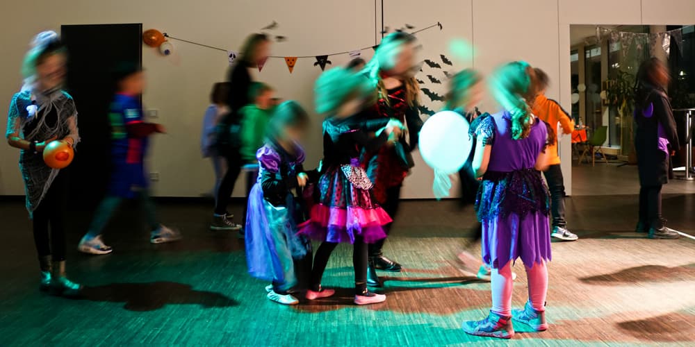 Children in Halloween costumes at an indoor party