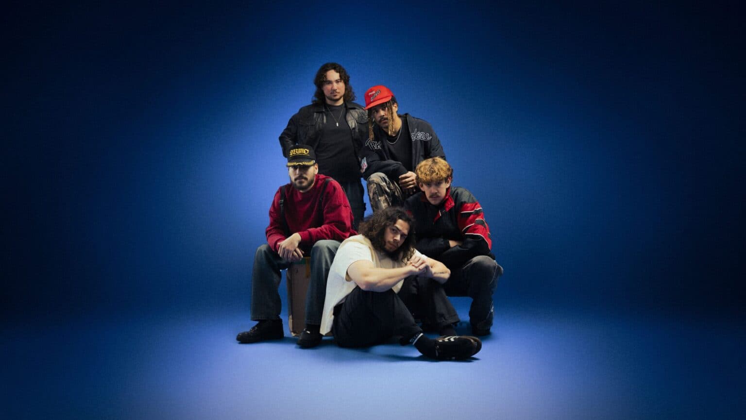 Press photograph of the band South Summit posed together outdoors.