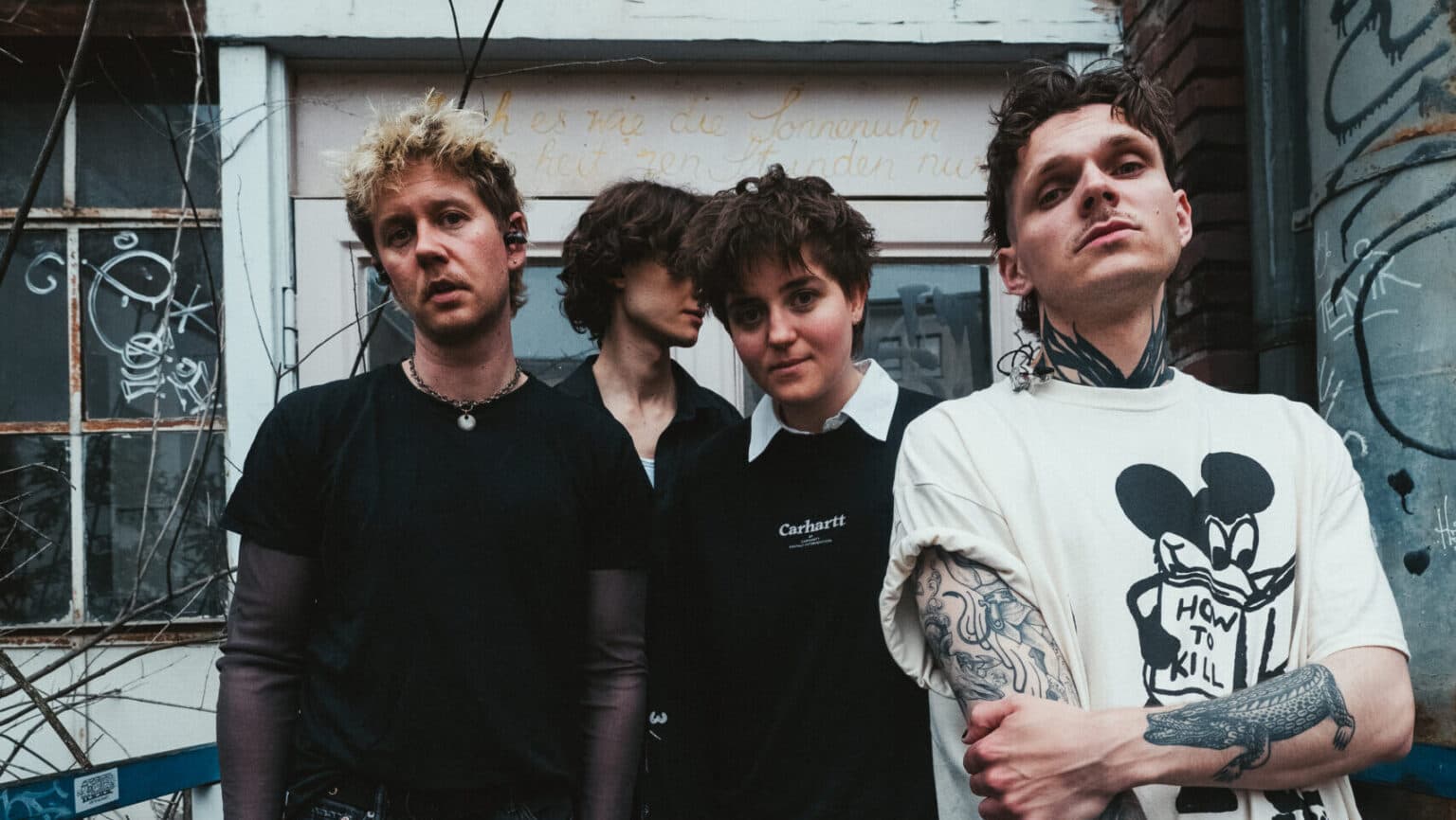 The band NIKRA posing together for a promotional press photo.