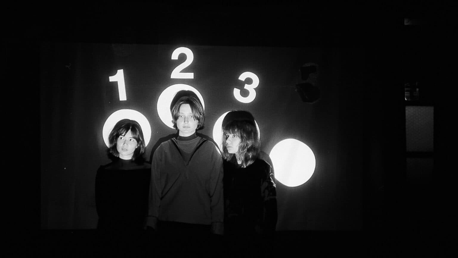 The three members of Horsegirl posed together in a casual outdoor portrait.