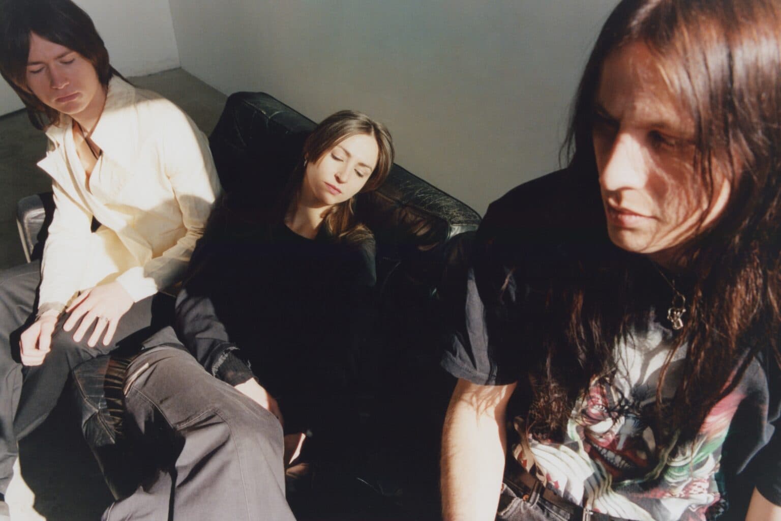 The three members of the band Roomer photographed together outdoors.