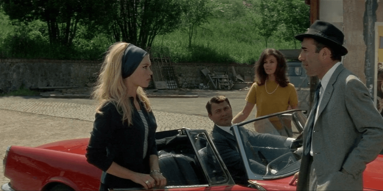 Still from Le Mépris with a Mediterranean villa and figures overlooking the sea