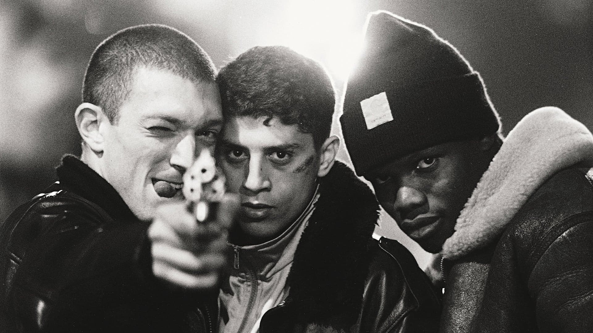 Black-and-white poster still from La Haine showing three young men on a Paris estate