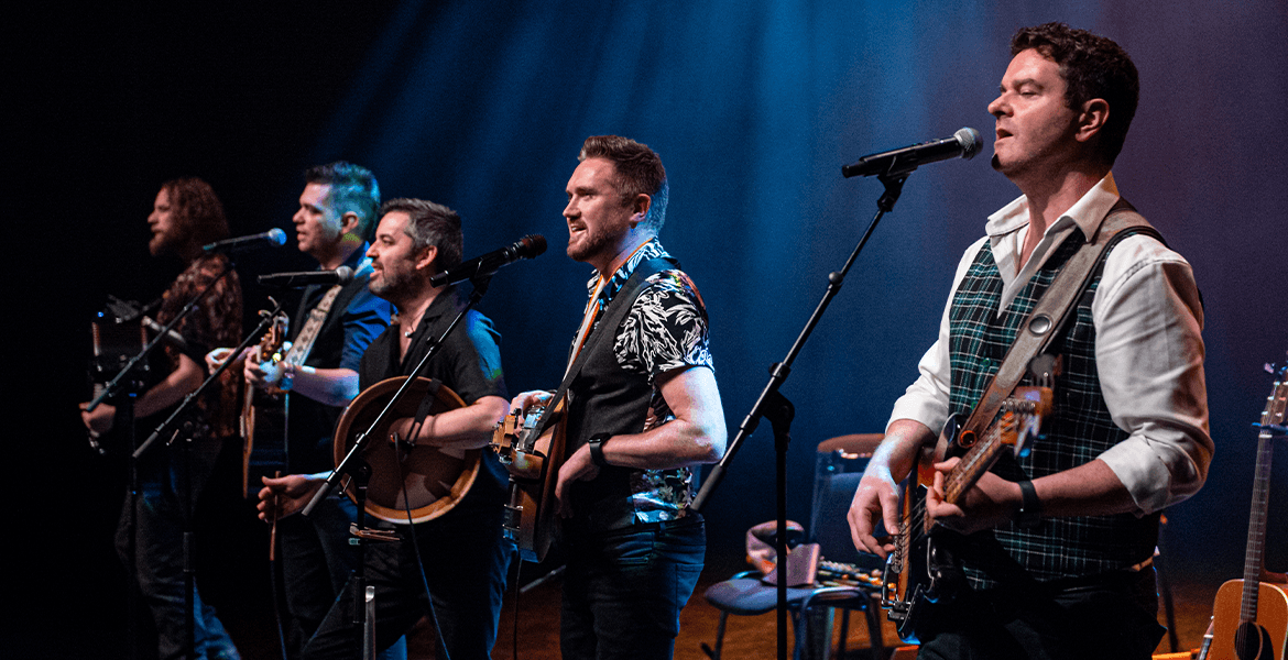 Promotional photo of the five members of Irish folk band The Kilkennys posing together for their tour.
