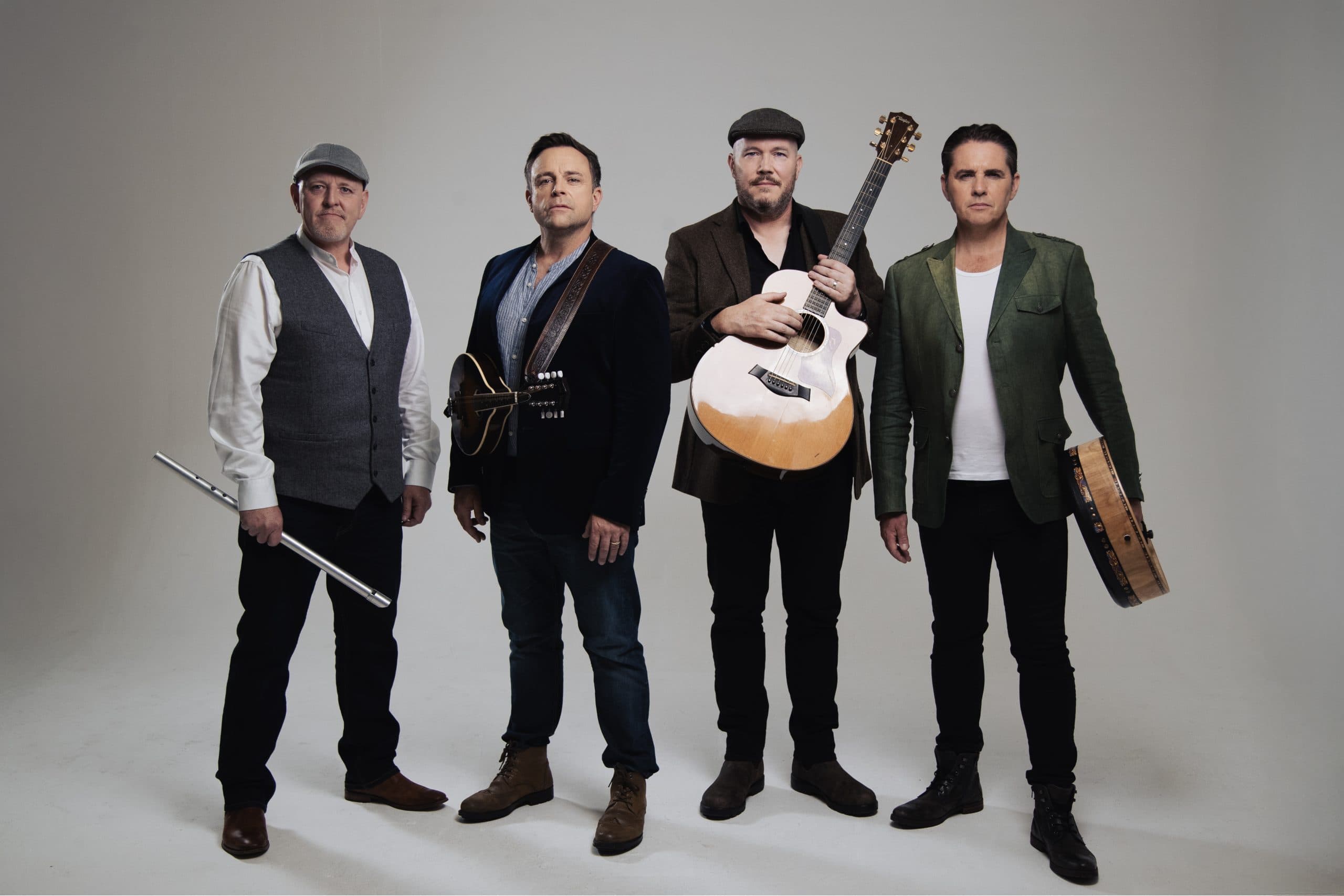 The four members of Irish folk band The High Kings posed together in a press photo.
