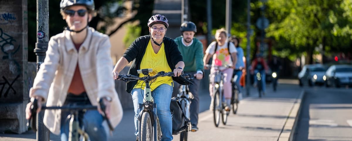 A group of cyclists riding through Munich on a guided city tour.