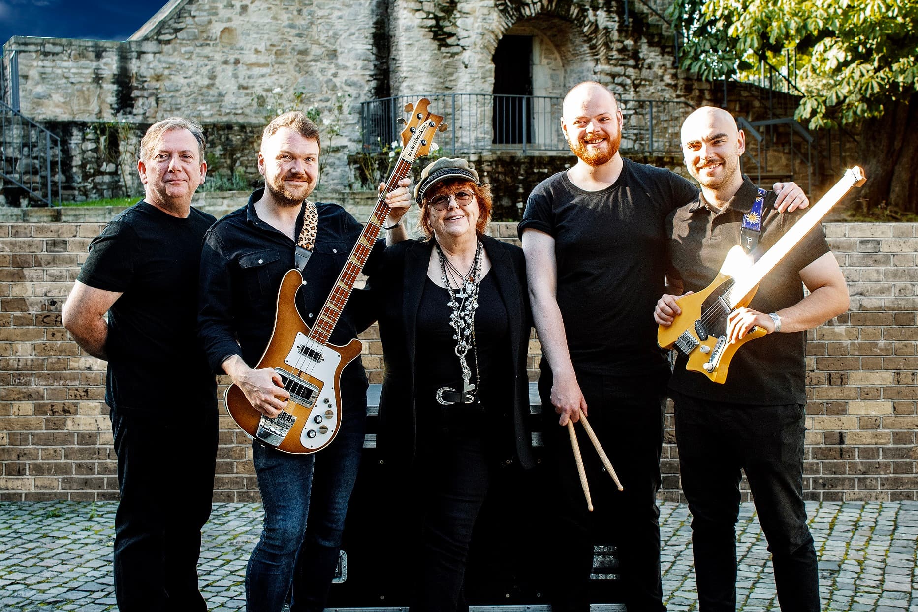 Singer Maggie Reilly standing with her band, promotional photo for the Everytime We Touch tour.