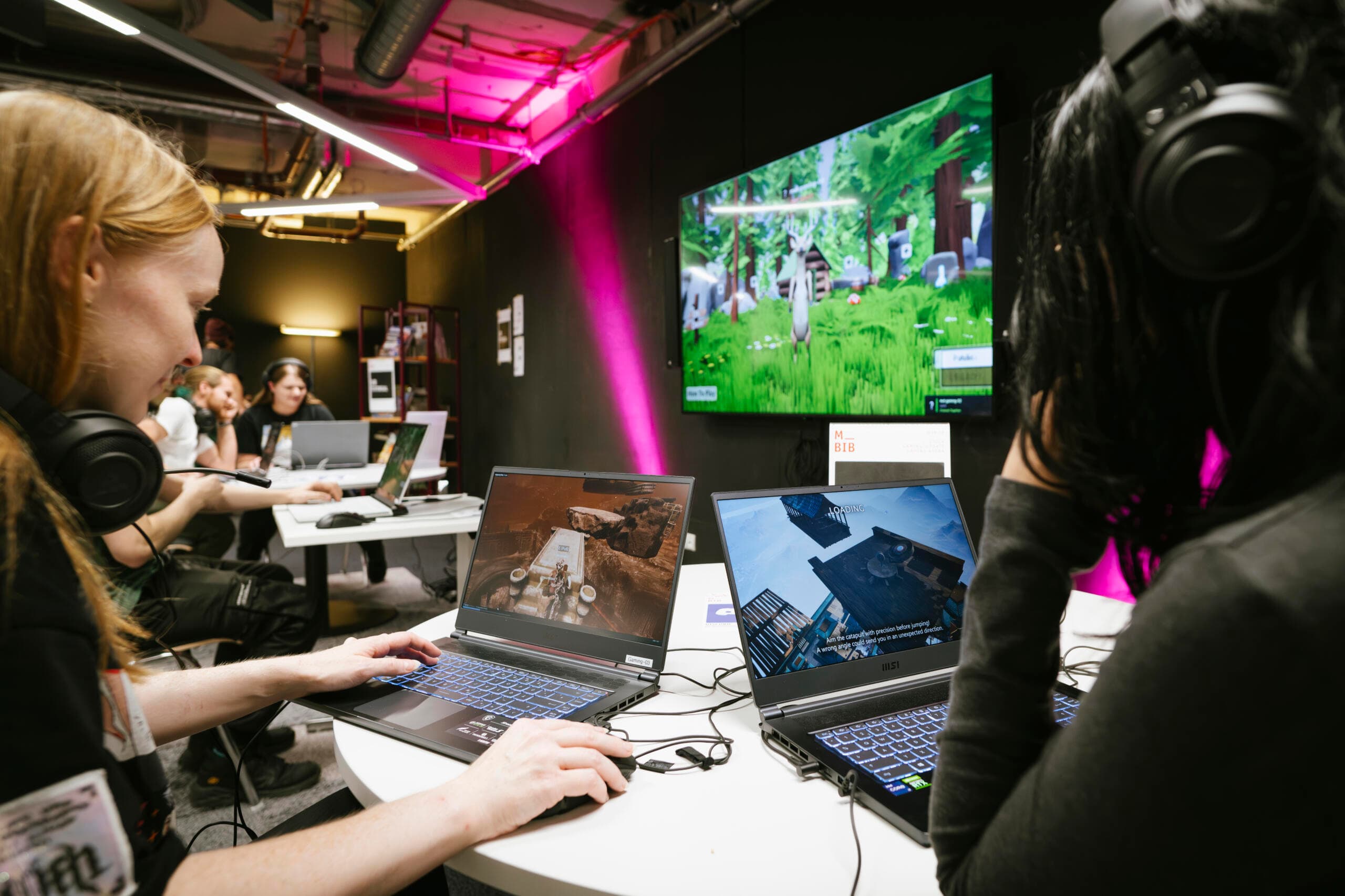 Young people playing video games at a library gaming event