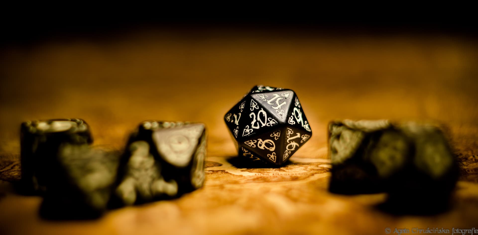 Dice and character sheets on a tabletop role-playing game table