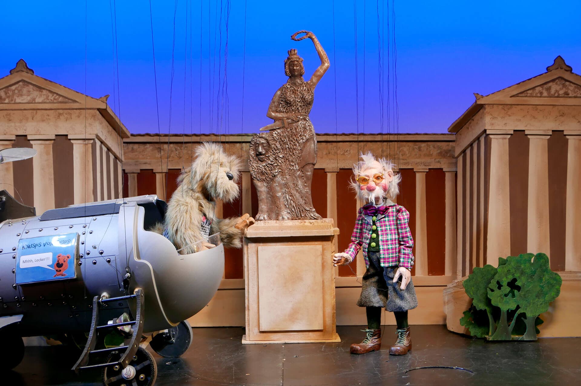 Korbinian Fox characters performing beside the time machine in the marionette production.